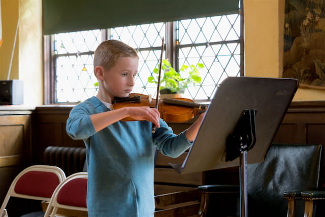 a boy playing a piano