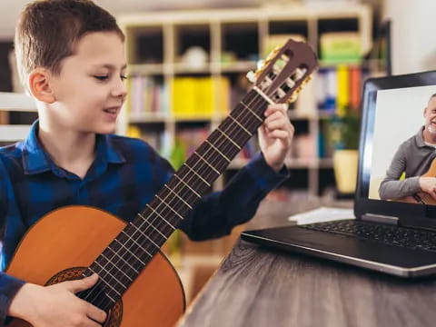 a boy playing a guitar