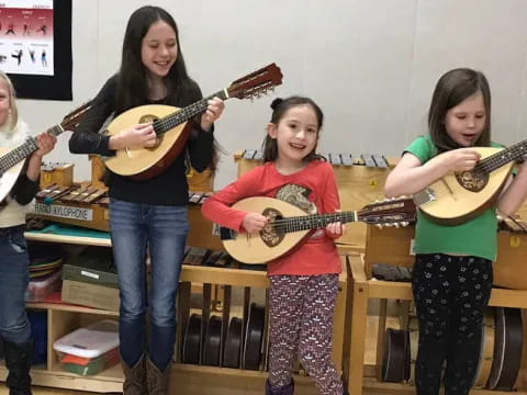 a group of women holding guitars