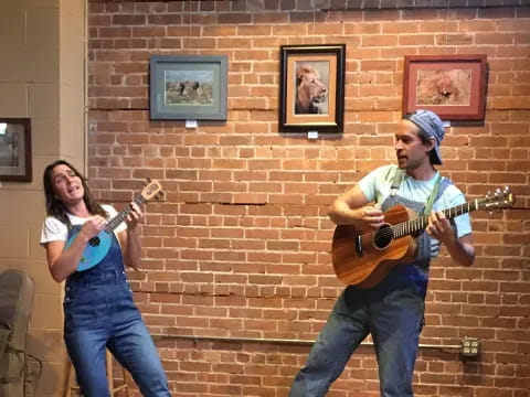 a man and woman playing guitars