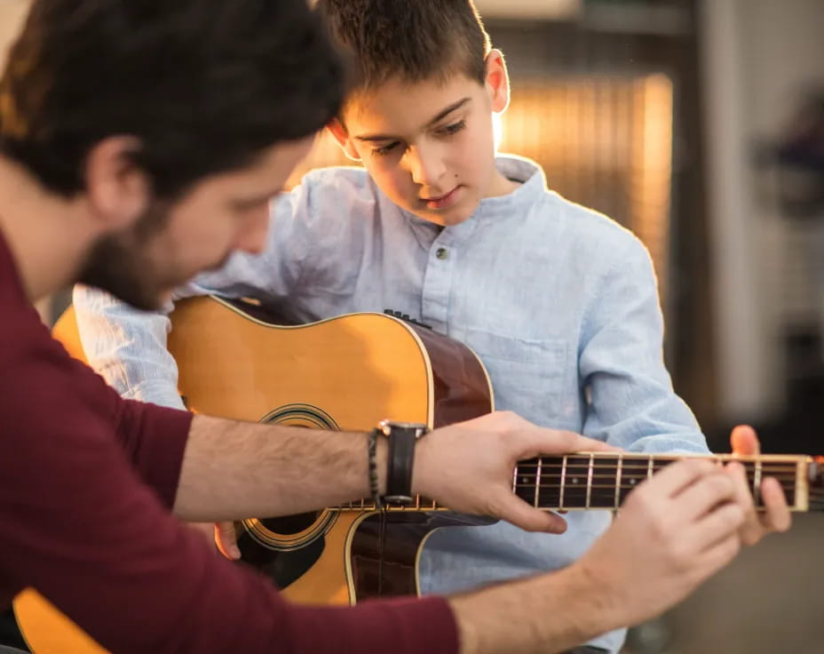 a couple of boys playing guitars