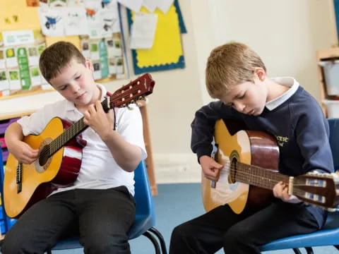 a couple of boys playing guitars