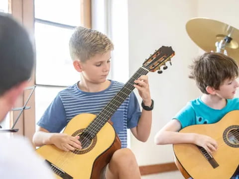 a group of boys playing guitars