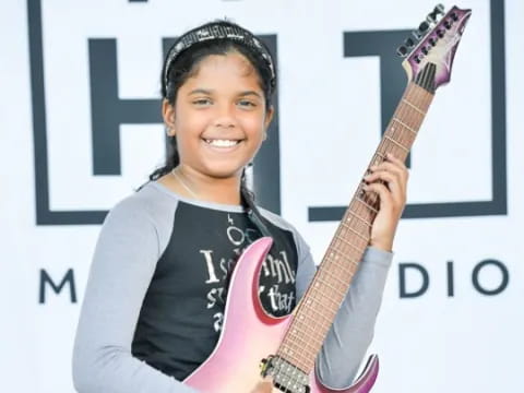a woman holding a guitar