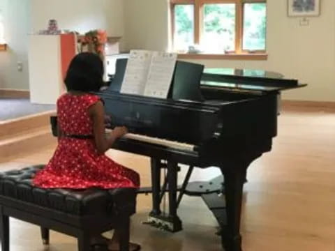 a girl playing a piano