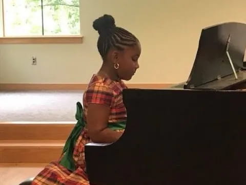 a woman sitting at a piano