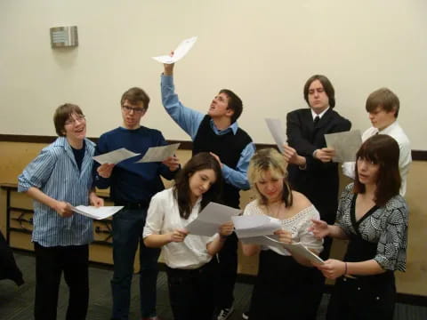 a group of people holding papers