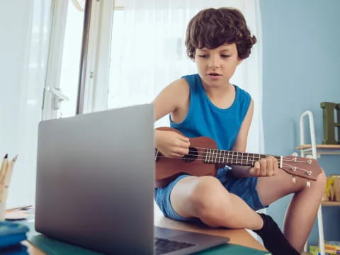 a young boy playing guitar