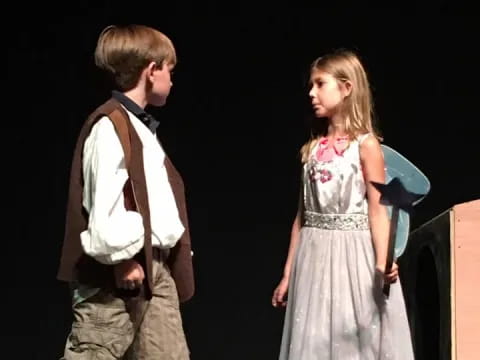 a boy and girl on stage