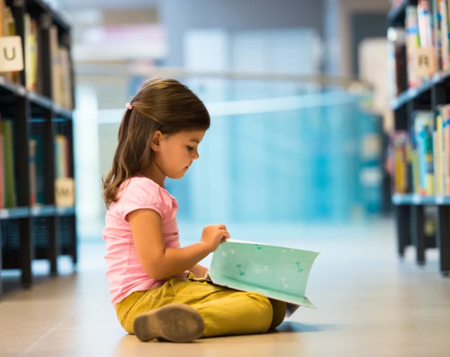 a young girl reading a book
