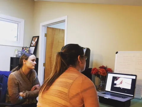 a woman talking to another woman