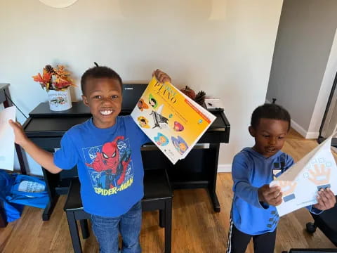 a couple of boys holding a book