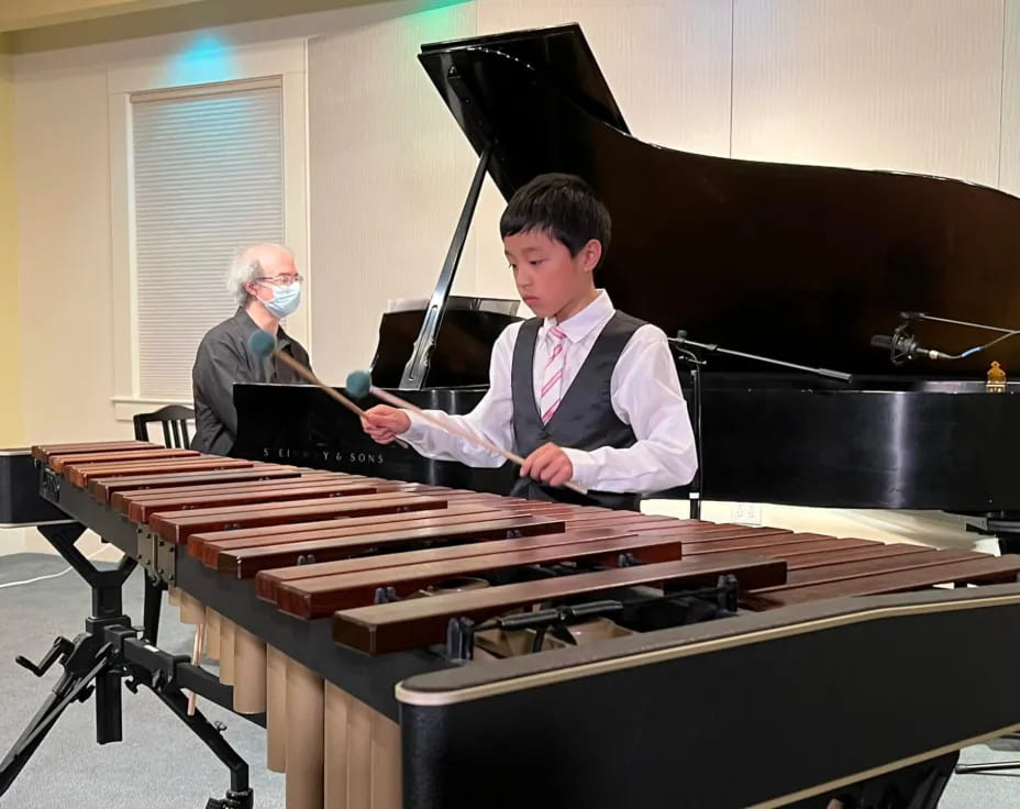 a boy playing a piano