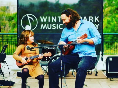 a man and woman playing guitar