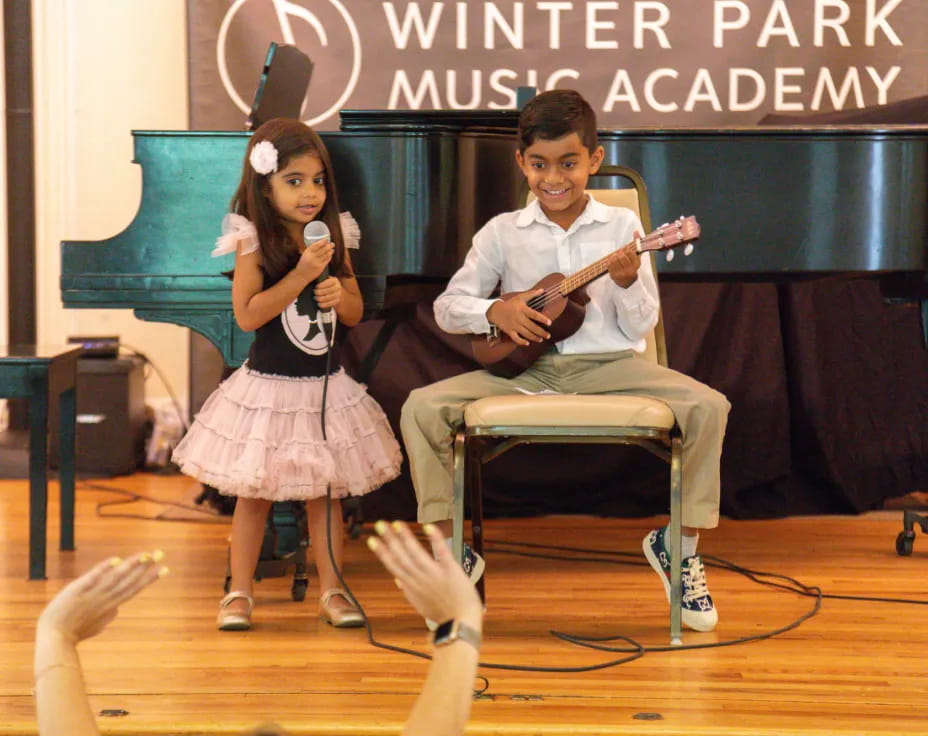 a man and woman singing on a stage