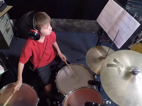a boy playing drums