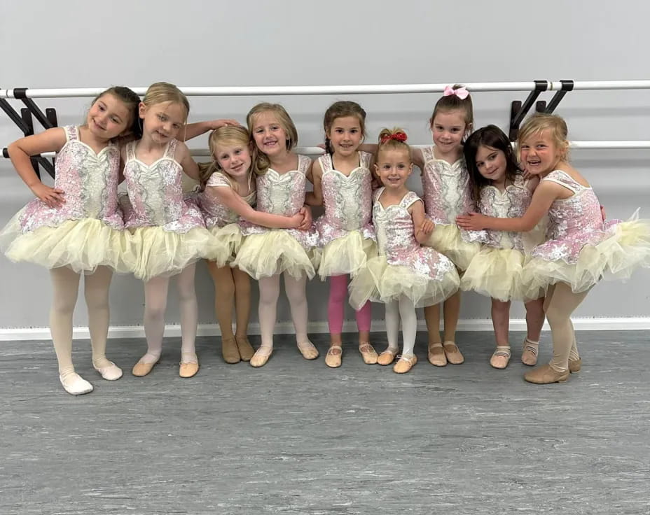 a group of women in white dresses
