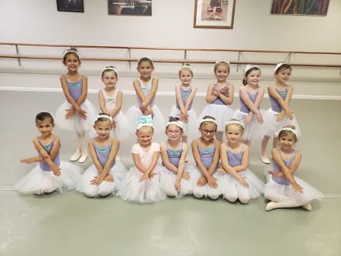a group of women in white dresses
