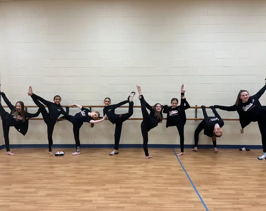 a group of women in black dancing