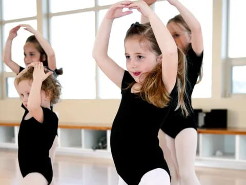 a group of women in black dresses