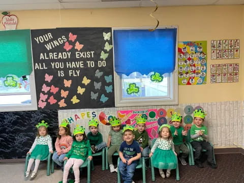 a group of children wearing green hats