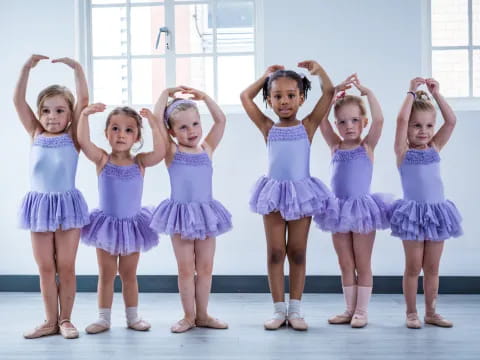 a group of girls in blue dresses