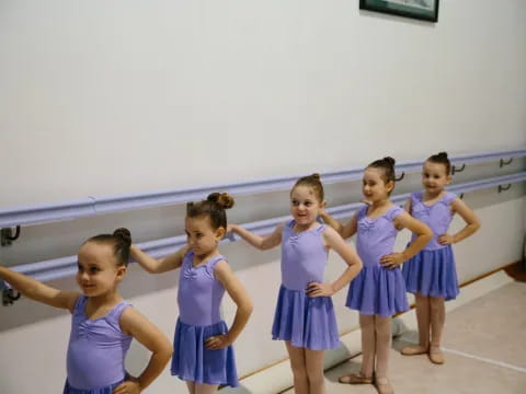 a group of girls in blue dresses