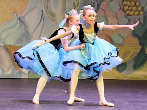 two women dancing on a stage