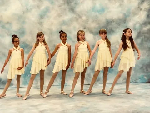 a group of women in white dresses