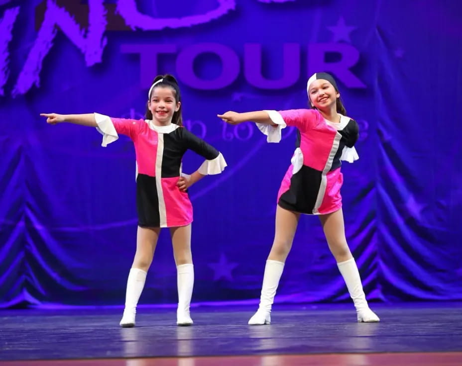 two women dancing on a stage
