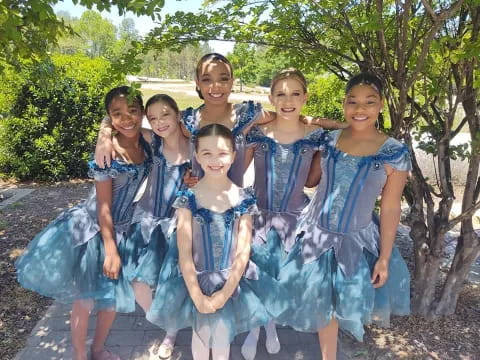 a group of women in dresses