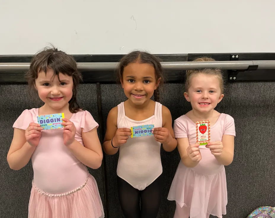 a group of girls holding cups