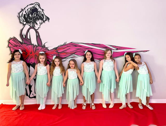 a group of girls in dresses