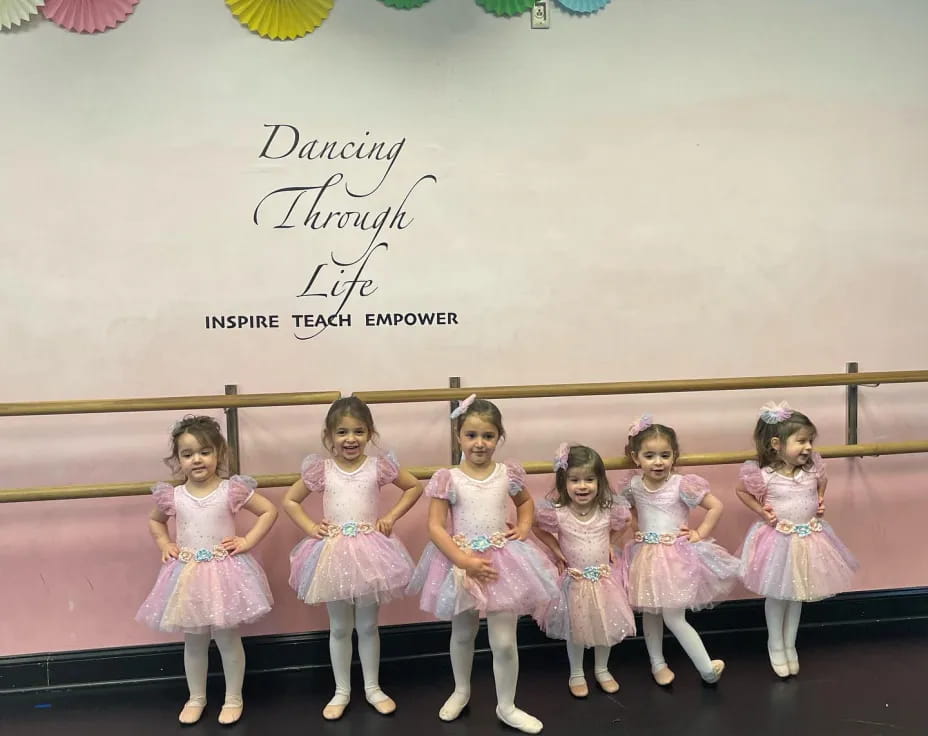 a group of girls in dresses