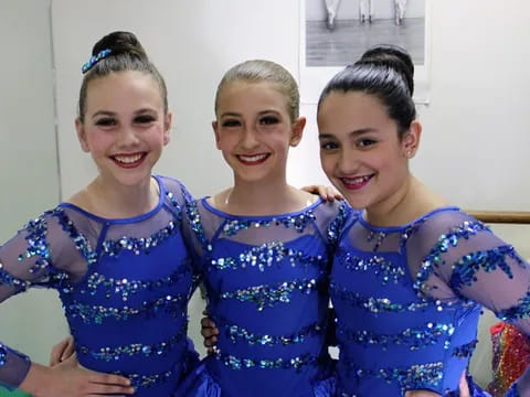 a group of girls in blue dresses