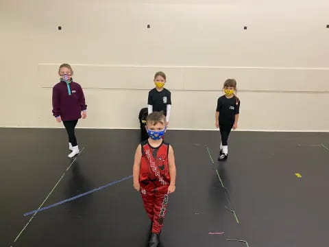 a group of kids wearing masks