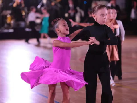 a boy and girl dancing on ice