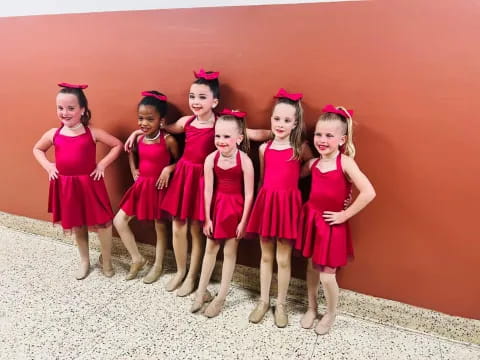 a group of girls in dresses