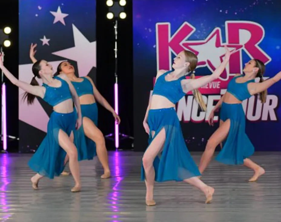 a group of women dancing on a stage