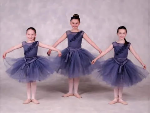 a group of girls in dresses