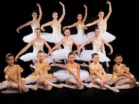 a group of women in white dresses
