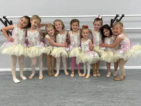 a group of women in white dresses