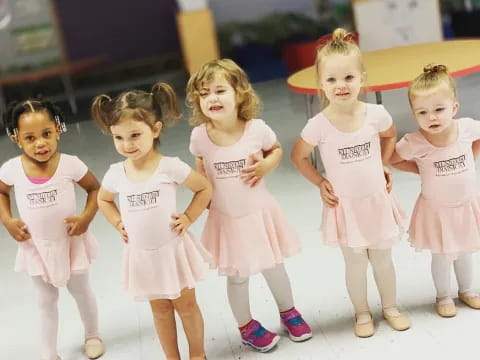 a group of girls in white dresses