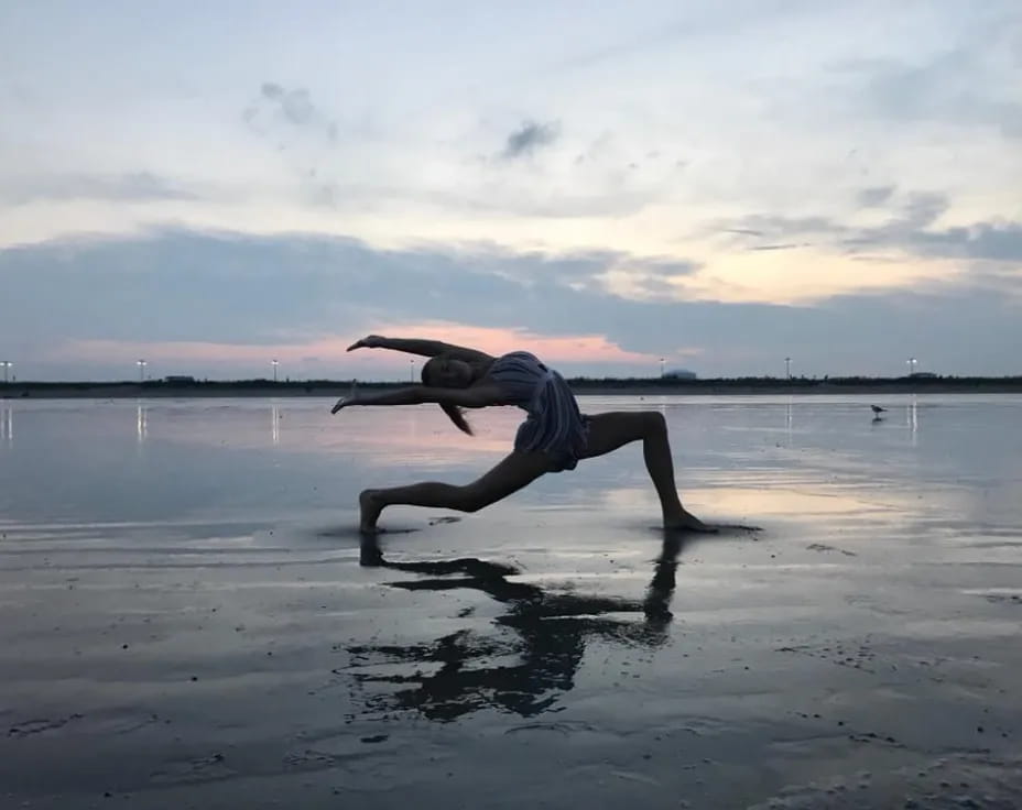 a person doing a handstand on a beach