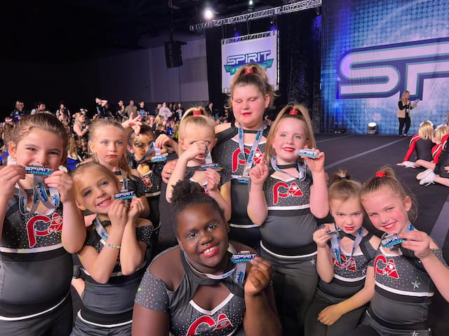 a group of children holding tooth brushes