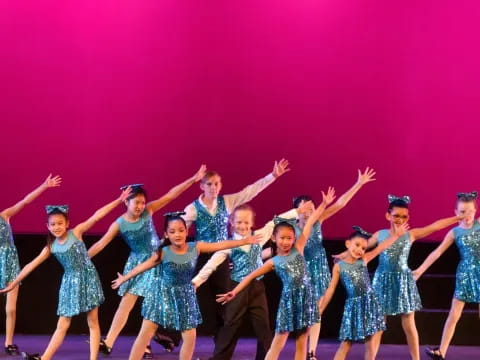 a group of girls in blue dresses