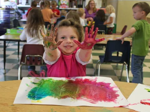 a girl holding a piece of art