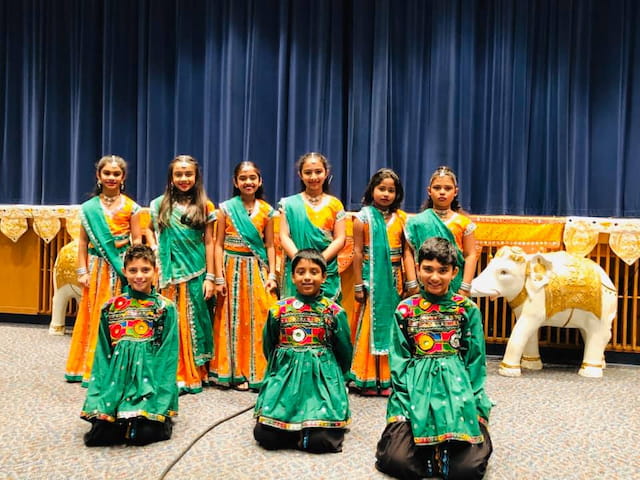 a group of people in colorful dresses