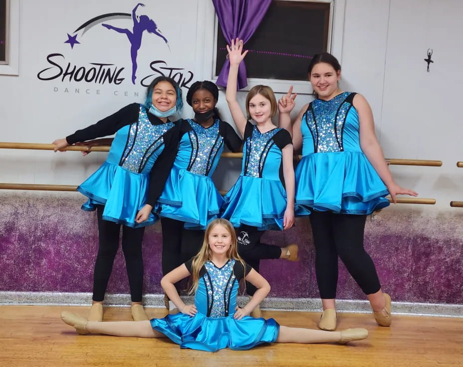 a group of people in blue dresses
