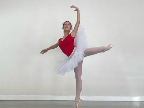 a woman in a white dress dancing